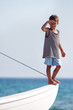 young boy in sailor shirt on board of sea yacht