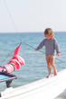 young happy child on ship on sea background