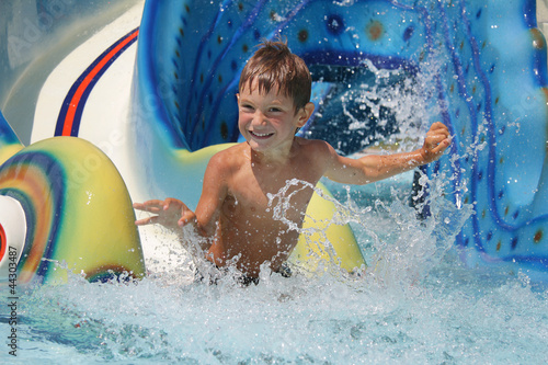 Photo: outdoor portrait of young smiling child having fun in aquapark outdoor portrait of young smiling child having fun in aquapark