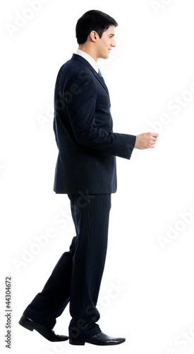 Photo: Full body of walking businessman, isolated Full body of walking businessman, isolated