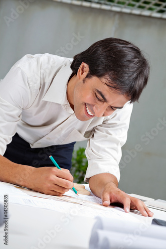 Photo: Architect Working On Blueprint Architect Working On Blueprint