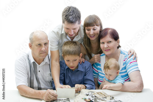 Photo: Happy family looking photo album Happy family looking photo album