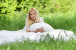 young beautiful woman relaxing on natural background