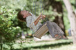young happy boy on swing in park