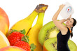 Foto: young woman with a weight scale and fresh fruit young woman with a weight scale and fresh fruit
