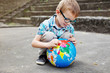Time for school. Kid with globe.