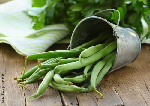 Photo: pods of green peas on a wooden table, rustic style pods of green peas on a wooden table, rustic style