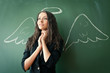 girl over chalkboard with funny picture