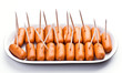 cocktail sausages; punctured tray with chopsticks