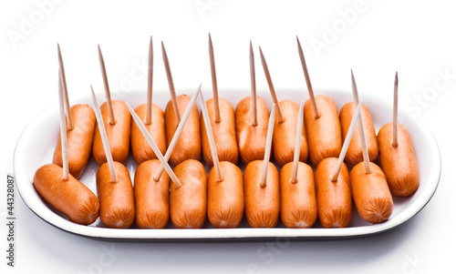 Photo: cocktail sausages; punctured tray with chopsticks cocktail sausages; punctured tray with chopsticks