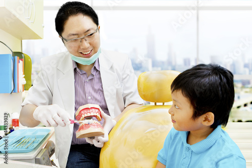 Photo: Asian dentist brushing teeth tutorial Asian dentist brushing teeth tutorial