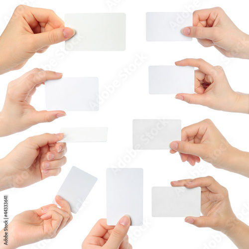 Photo: Hands hold business cards on white background Hands hold business cards on white background