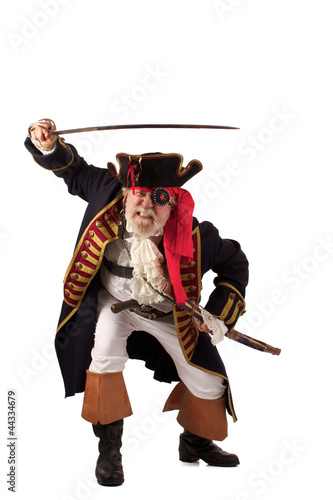 Photo: Classic bearded pirate captain lunging with raised sword. Classic bearded pirate captain lunging with raised sword.