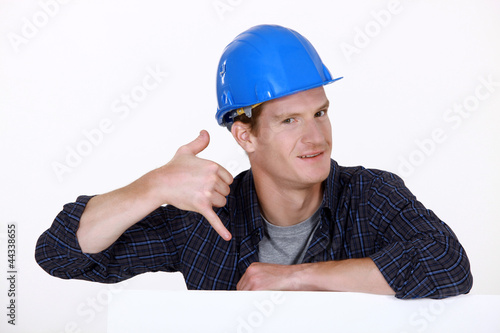 Photo: Manual worker making a phone shape with his hand Manual worker making a phone shape with his hand