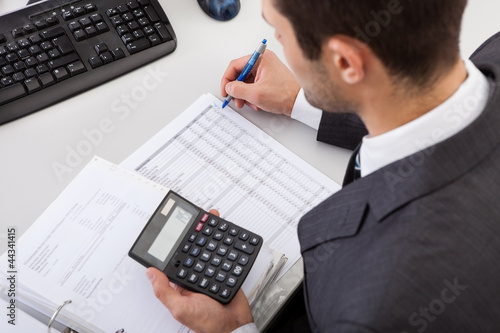 Photo: Accountant working at the office Accountant working at the office