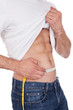 Muscular man measuring waist