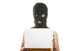 Woman in balaclava holding blank card