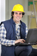 Builder sat with laptop