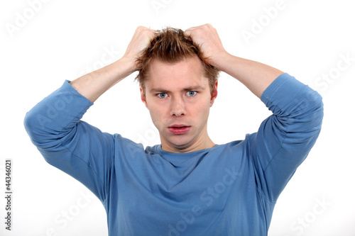 Photo: Man pulling own hair Man pulling own hair