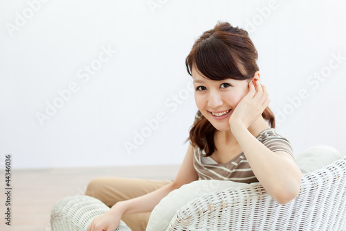 Photo: Beautiful young woman relaxing in the room Beautiful young woman relaxing in the room