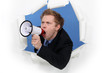 Businessman yelling into a blowhorn