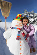 Girl next to snowman