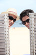 senior and young man relaxing on beach