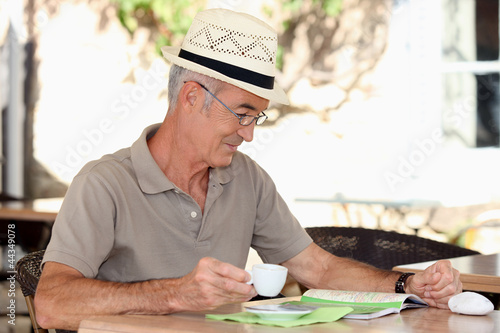 Photo: Older man at an alfresco cafe Older man at an alfresco cafe