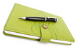 Photo: Pen and green notebook Pen and green notebook