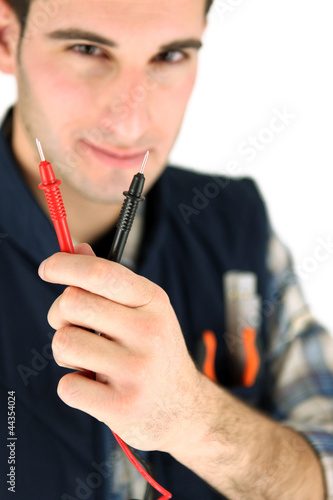 Photo: Electrician holding probes from voltmeter Electrician holding probes from voltmeter