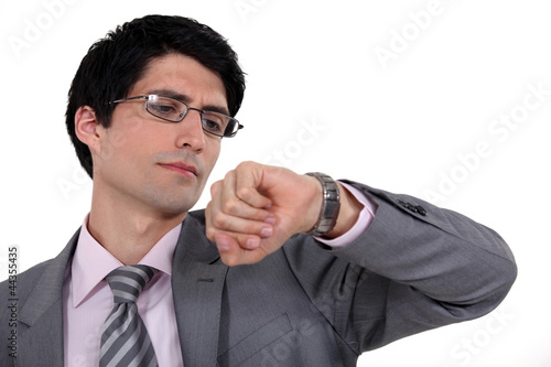 Photo: A businessman checking the time, A businessman checking the time,