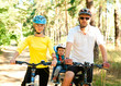 Photo: Family on the bike in the sunny forest Family on the bike in the sunny forest