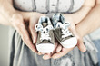 Newborn baby booties in parents hands