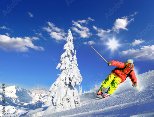 Photo: Skier skiing downhill in mountains Skier skiing downhill in mountains