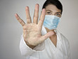 Photo: doctor with stop gesture - grey background doctor with stop gesture - grey background