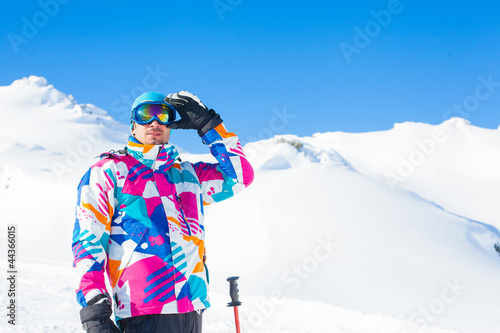 Photo: Young man with skis and a ski wear Young man with skis and a ski wear