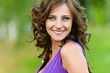 Photo: young woman in a purple dress happily smiling young woman in a purple dress happily smiling