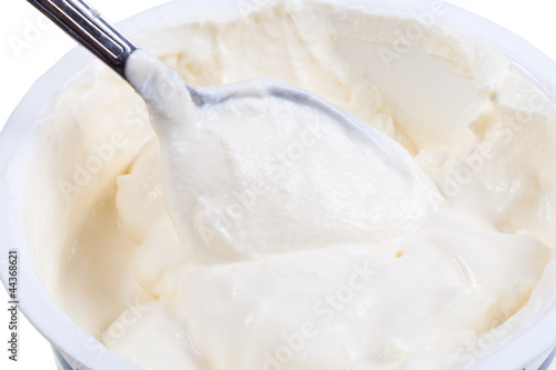 Photo: metal spoon in tub of sour cream metal spoon in tub of sour cream