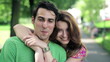 Happy couple in love in the park, steadicam shot