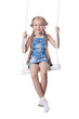 Happy girl sitting on swing