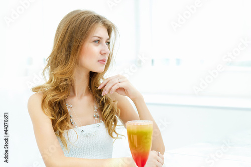 Photo: Young woman with a glass of drink Young woman with a glass of drink