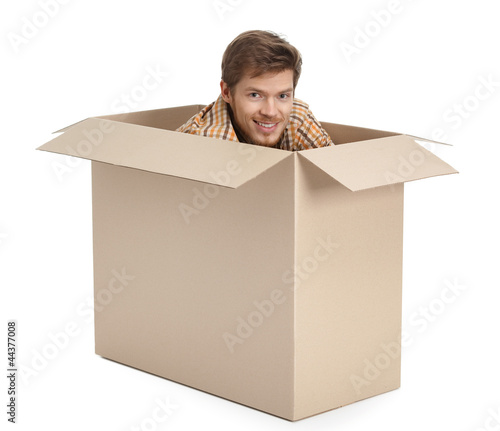 Photo: Pretty man hides inside the cardboard Pretty man hides inside the cardboard
