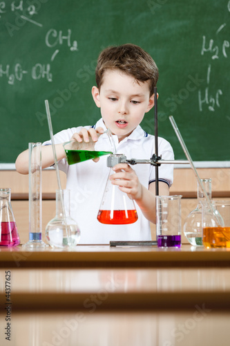Photo: Little chemist holds scientific experiment Little chemist holds scientific experiment