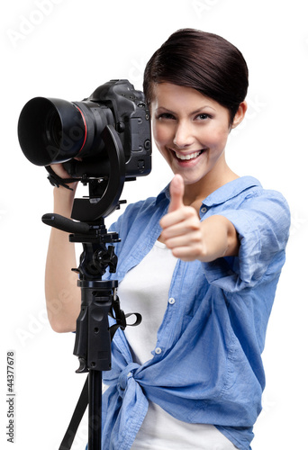 Photo: Woman takes photos holding photographic camera Woman takes photos holding photographic camera