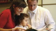 Video: Happy family viewing photos at christmas eve Happy family viewing photos at christmas eve