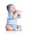 adorable baby girl drinking milk from bottle without help