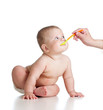 Little baby feeding with a spoon