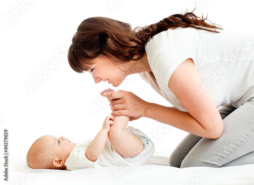Photo: joyful mother playing with her baby infant joyful mother playing with her baby infant