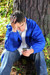 sad young man with phone