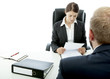 Photo: beard business man brunette woman at desk read contract beard business man brunette woman at desk read contract